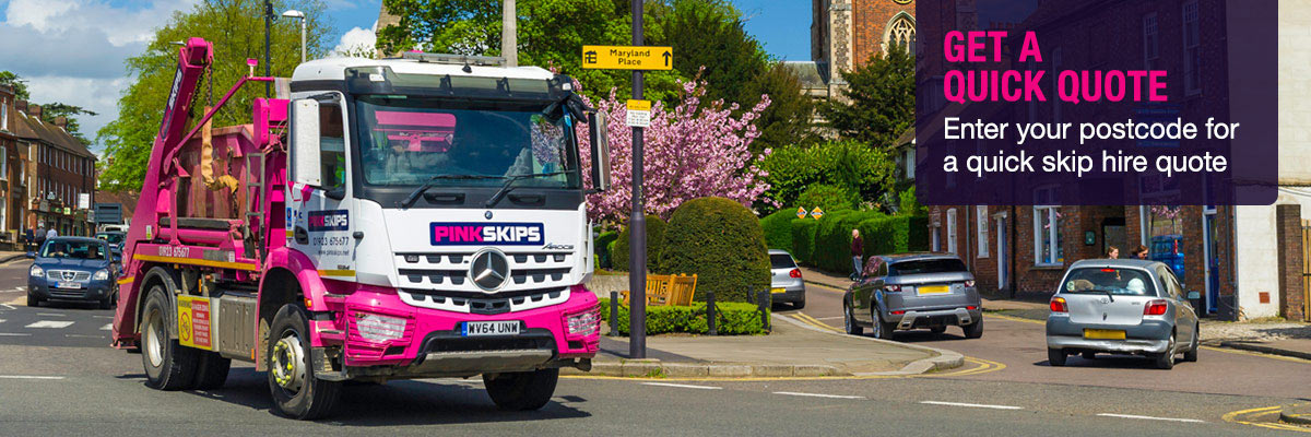 pink skip lorry in town centre